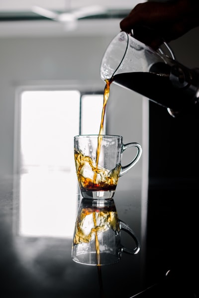 Transparent glass mugs with brown liquid
